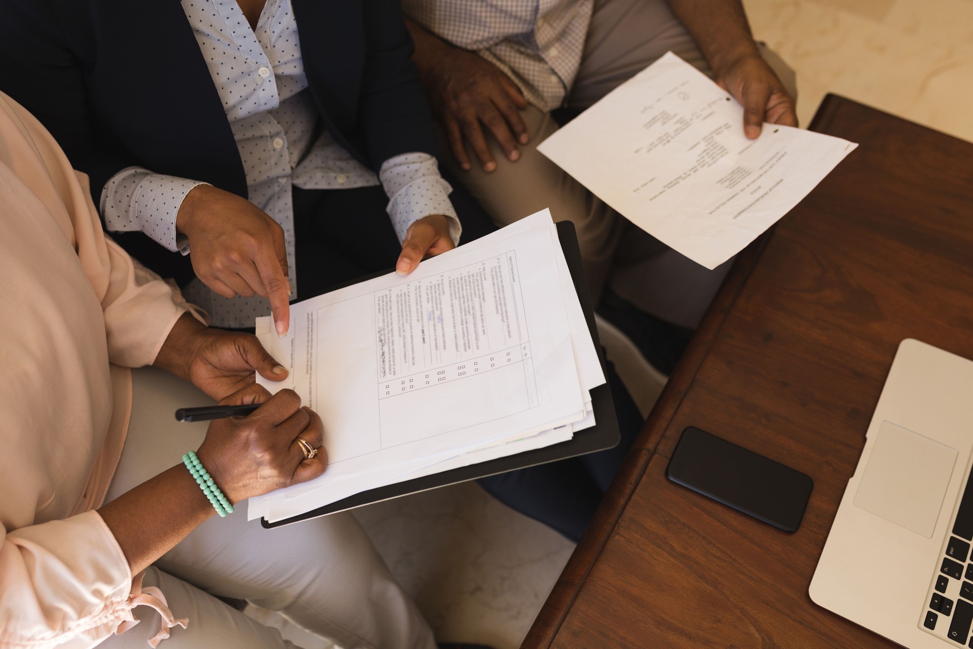 Senior woman signing property contract with real estate agent